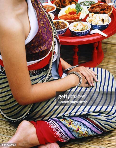 young woman wearing traditional dress by thai food - hugh sitton stock pictures, royalty-free photos & images