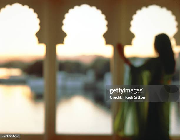 a woman looking at the pichola sea, india, rajashtan - hugh sitton india stockfoto's en -beelden