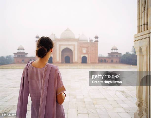 young woman in sari at taj mahal - hugh sitton stock pictures, royalty-free photos & images