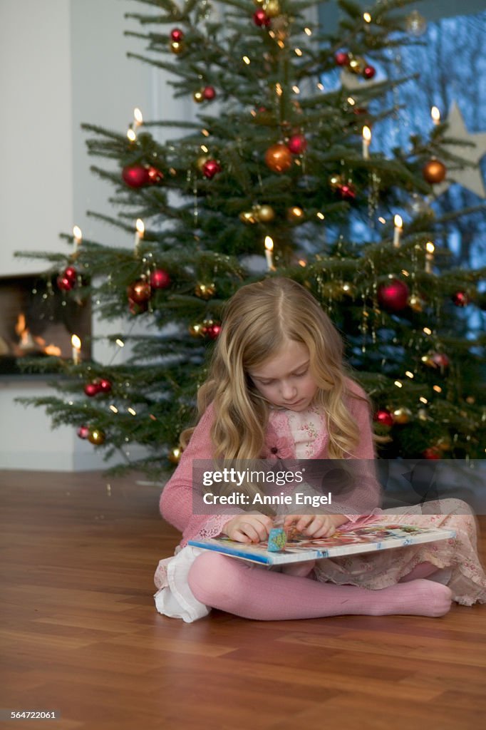 Girl with Advent Calendar at Christmas Tree
