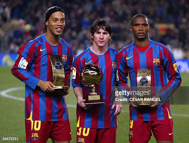 Barcelona's Brazilian Ronaldinho Samuel Eto'o of Cameroon hold the trophies of FIFA World Player of the Year and Argentinian Leo Messi with his...