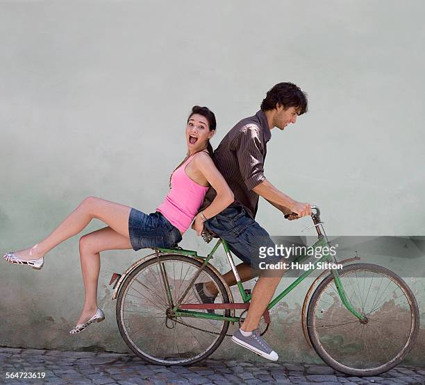 young couple on a bicycle - hugh sitton fotografías e imágenes de stock