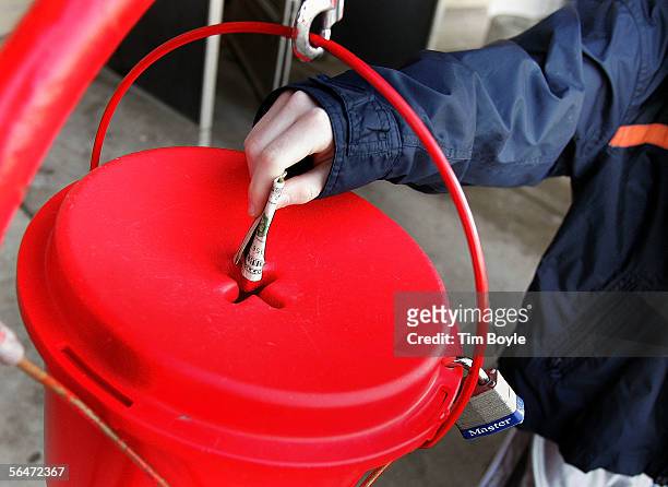 Donation is made into Salvation Army bell ringer Juanita Brown's red Holiday donation kettle December 20, 2005 in Park Ridge, Illinois. Since 1865,...