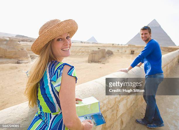 tourist couple visiting the pyramids of giza - hugh sitton stock pictures, royalty-free photos & images