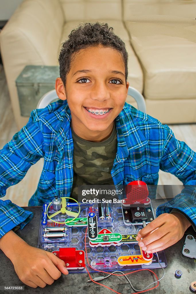 Portrait of boy with science project, smiling