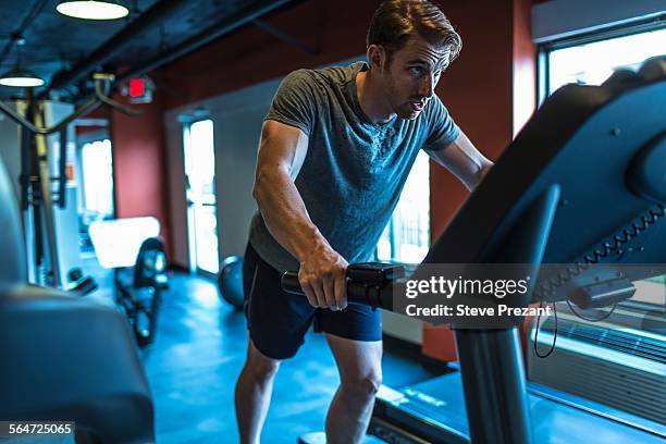 exhausted mid adult man on gym treadmill - treadmill stock pictures, royalty-free photos & images