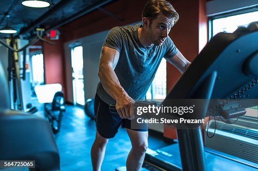 Exhausted mid adult man on gym treadmill Exhausted mid adult man on gym treadmill