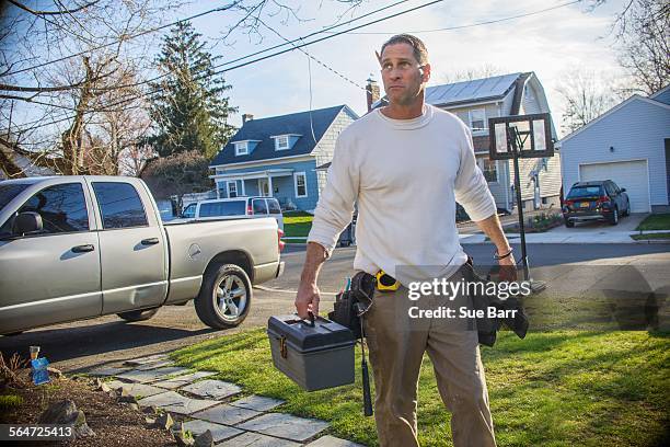 handyman going to house call - plumber man stockfoto's en -beelden