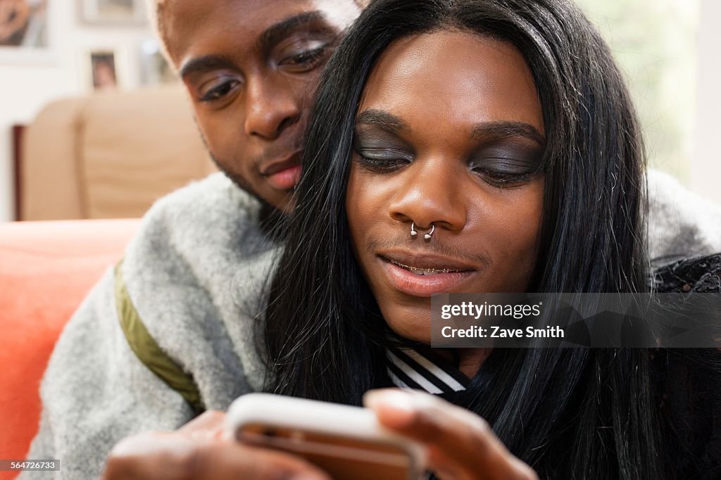 Young male couple looking at smartphone together