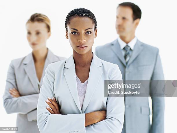portrait of a businesswoman with two business executives standing behind her - african cornrow braids stock pictures, royalty-free photos & images