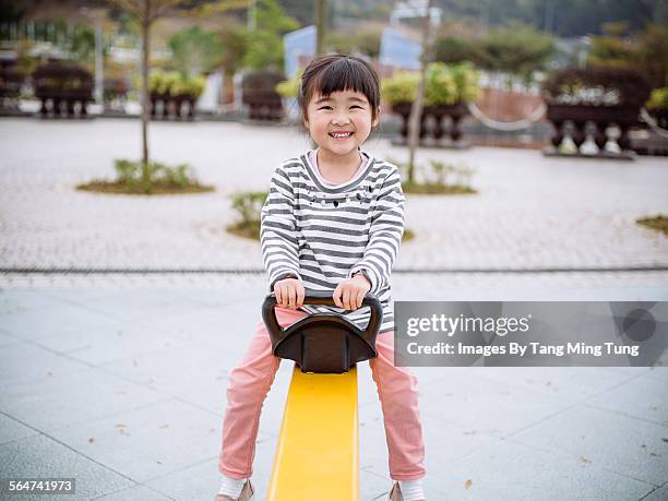 child playing joyfully at playground - long sleeved fotografías e imágenes de stock