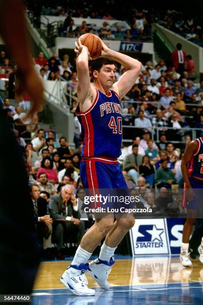 Bill Laimbeer of the Detroit Pistons looks to pass against the Philadelphia 76ers during a 1993 NBA game at the Spectrum in Philadelphia,...