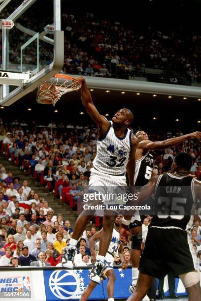 Shaquille O'Neal of the Orlando Magic dunks against the San Antonio Spurs during a 1993 NBA game at the Orlando Arena in Orlando, Florida. NOTE TO...
