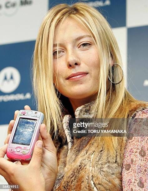 Russian tennis player Maria Sharapova shows off a mobile phone "Pink M1000" which was made by Motorola exclusively for her to use during her stay in...