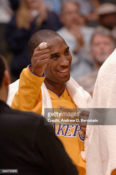 Kobe Bryant of the Los Angeles Lakers raises his hand to the crowd after scoring sixty-two points in a win against the Dallas Mavericks on December...
