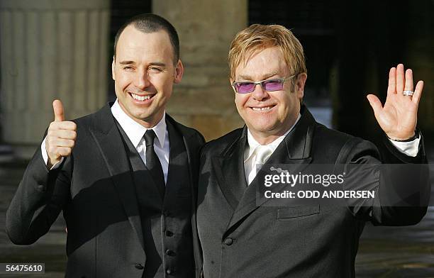 United Kingdom: British singer Sir Elton John and his partner David Furnish pose for photographs at the Guildhall in Windsor, 21 December 2005, after...