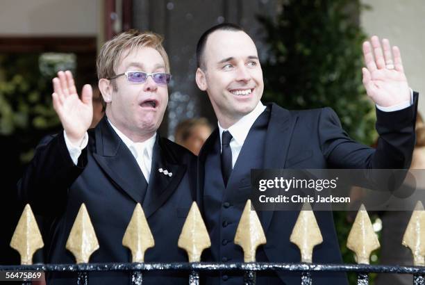 Celebrity couple Sir Elton John and David Furnish wave as they leave as a married couple following their civil partnership ceremony at the Guildhall,...