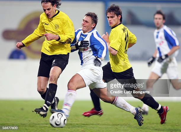 Ruediger Rehm and Thomas Woehrle of Offenbach challenge Marcel Schied of Rostock for the ball during the last sixteen match of the DFB German Cup at...