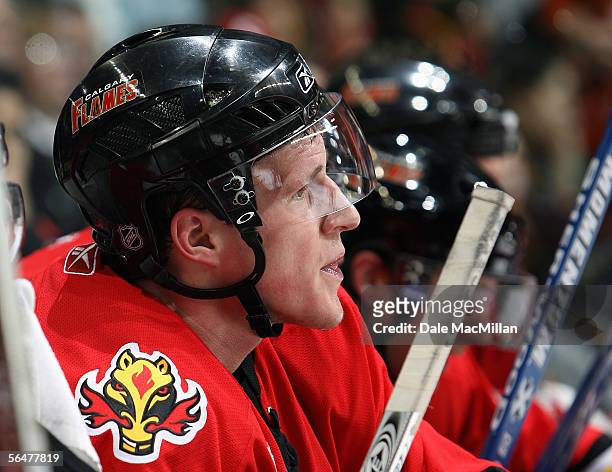 Dion Phaneuf of the Calgary Flames looks on from the bench during their NHL game against the Boston Bruins at Pengrowth Saddledome on December 17,...