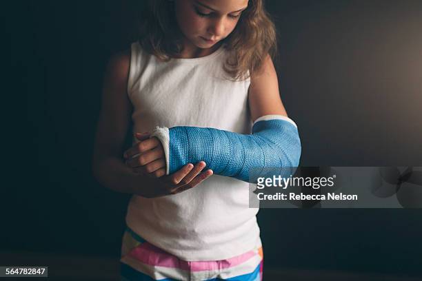 girl with broken arm - orthopedic cast stock-fotos und bilder