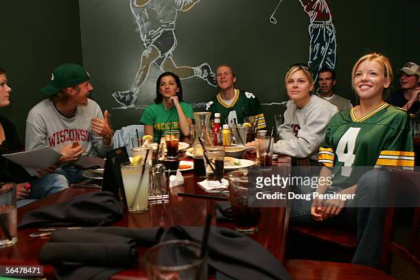 Speed Skater Casey FitzRandolph, center, and several of the other Wisconsin native speed skaters ritually gather to watch their Green Bay Packers on...