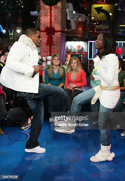 Actor/singer Jamie Foxx dances with an audience member onstage during MTV's Total Request Live at the MTV Times Square Studios on December 21, 2005...