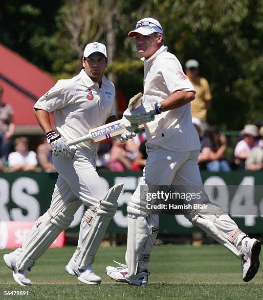 Brad Hodge and Dean Jones of Australia cross for a run during the Six-a-Side match between Australia and the Essendon AFL Team at Windy Hill on...