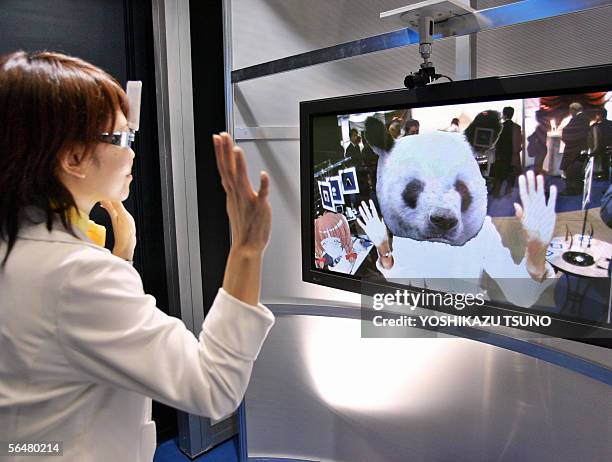 Japan's telecom giant NTT employee demonstrates the new 3D CG morphing system "Dream Boutique" to change her face to animal's head at the NTT group...