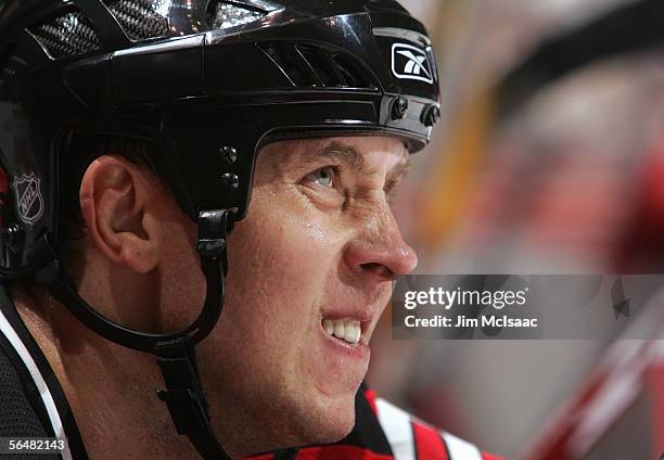 Alexander Mogilny of the New Jersey Devils makes a face while sitting on the bench during their NHL game against the Boston Bruins on November 29,...