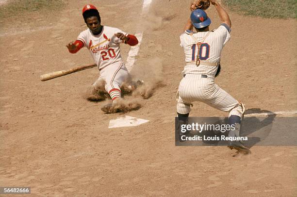 Lou Brock of the St. Louis Cardinals slides into home plate during a game circa 1964 to 1979. Lou Brock played for the St. Louis Cardinals from...