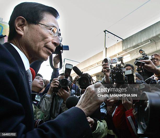 Pro-democracy legislator Martin Lee talks to members of the press outside the Kwun tong court in Hong Kong, 23 December 2005. Fourteen...
