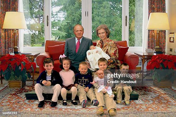 In this handout image from the Spanish Royal House, Spanish King Juan Carlos and Queen Sofia, holding their newborn grandchild Leonor, posing with...