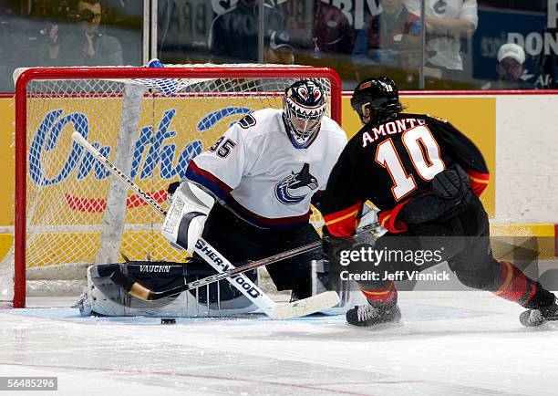 Tony Amonte of the Calgary Flames dekes Alex Auld of the Vancouver Canucks before scoring a shootout goal during their NHL game at General Motors...