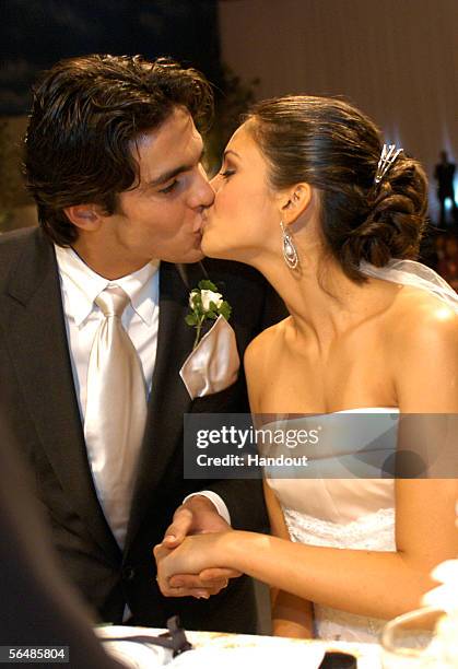 In this handout photo, Brazilian soccer star Kaka , who plays for Italian club AC Milan, kisses his bride Caroline Celico during their wedding in Sao...