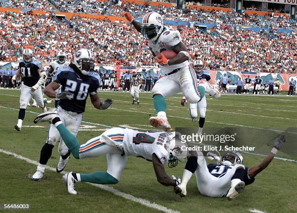 Running back Ricky Williams of the Miami Dolphins goes airborne for a first down against the Tennessee Titans in the second quarter on December 24,...
