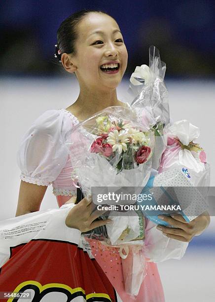 Japanese figure skater Mao Asada is all smile after her free skating of women's singles event in the Japan Figure Skating Championships in Tokyo, 25...