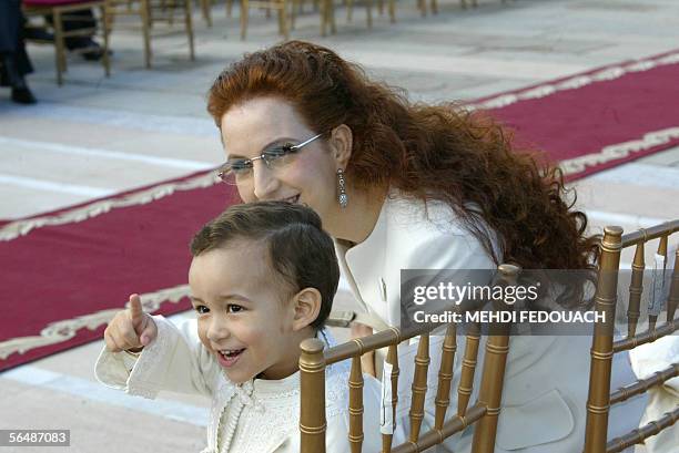 The son of Moroccan King, the Crown Prince Hassan points whilst his mother the Princess Lalla Salma looks towards his gesture 16 November 2005 as the...