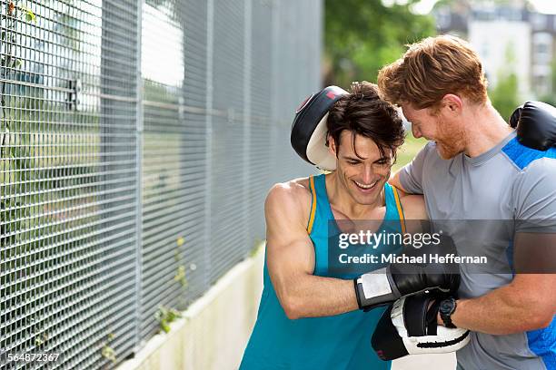 personal trainer having fun with client - combat sport stock pictures, royalty-free photos & images