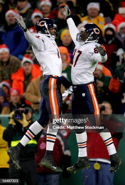 Justin Gage of the Chicago Bears congratulates teammate Muhsin Muhammad after Muhammad's touchdown against the Green Bay Packers December 25, 2005 at...