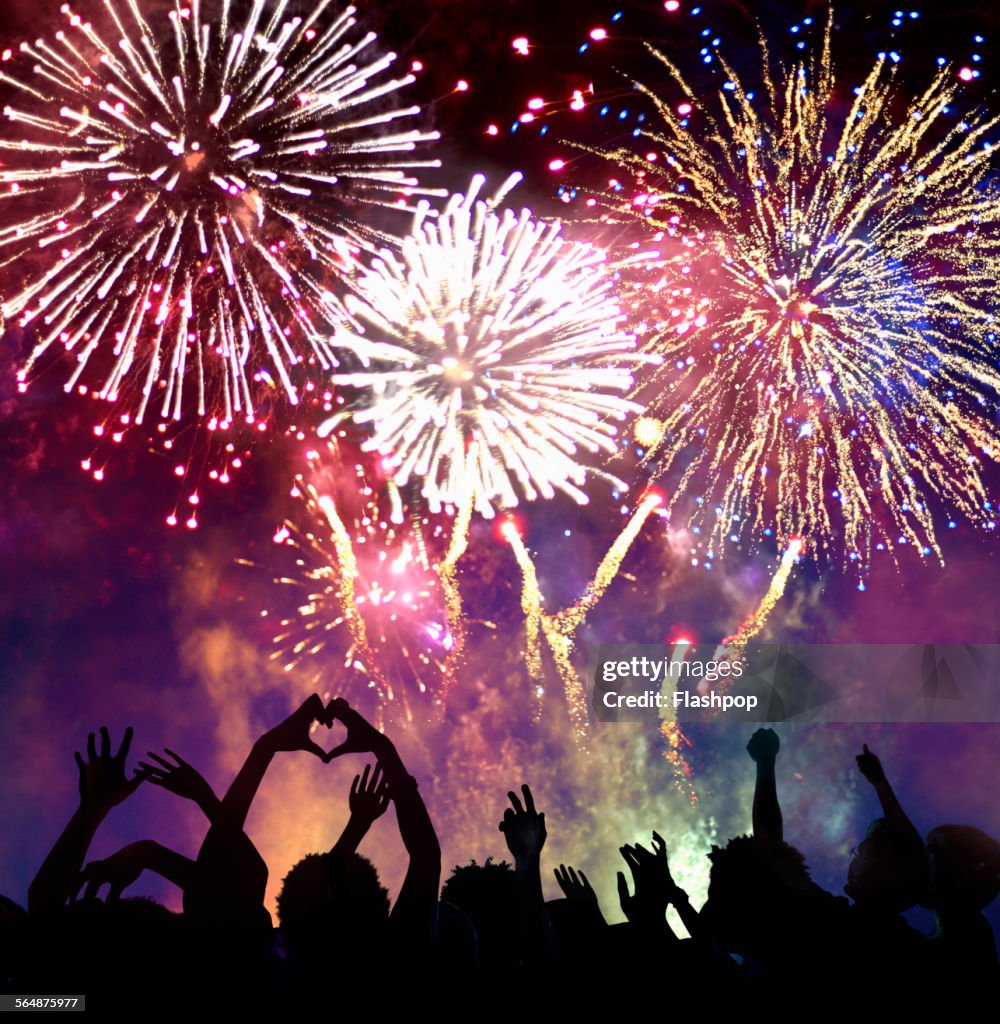 Crowd of people enjoying firework display