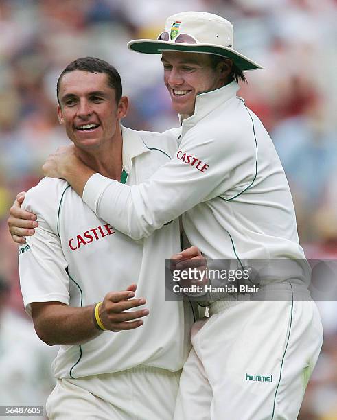 Andre Nel and AB De Villiers of South Africa celebrates the wicket of Shane Warne of Australia during day one of the Second Test between Australia...