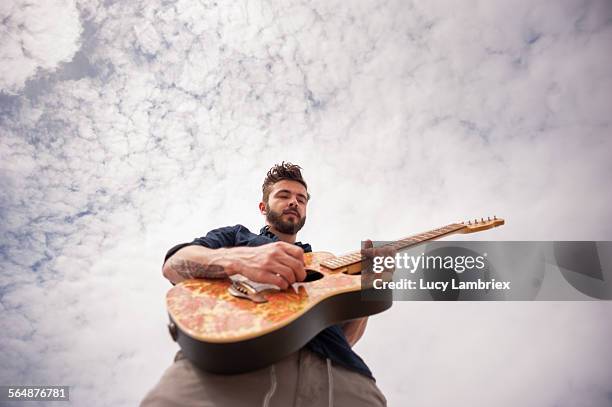 guitar player seen from below. - guitarist bildbanksfoton och bilder