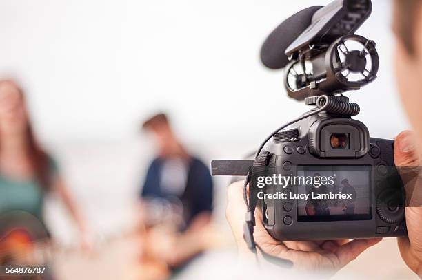 making of a videoclip on the beach - cameraman stock pictures, royalty-free photos & images