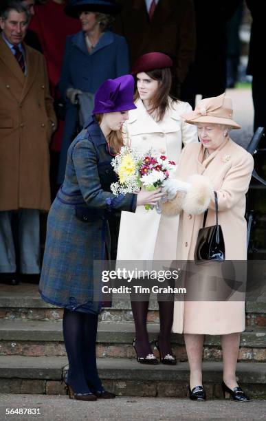 Queen Elizabeth II is helped by her grandaughters Princess Beatrice and Princess Eugenie after attending Christmas Day service at Sandringham Church...