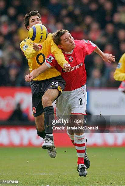 Matt Holland of Charlton and Francesc Fabregas of Arsenal battle for the ball during the Barclays Premiership match between Charlton and Arsenal at...