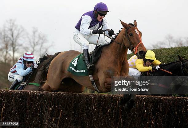 Kicking King ridden by Barry Geraghty jumps the final fence ahead of Monkerhostin ridden by Richard Johnson and Impek ridden by Tony McCoy and goes...