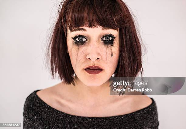 sad young woman crying with black mascara tears - woman mascara stock pictures, royalty-free photos & images