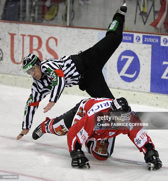 Team Canada's Stacy Roest crashes into referee Danny Kurmann during a penalty session that Team Canada lost against Russian HC Metallurg Magnitogorsk...