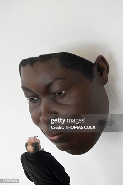 Visitor looks at "Mask III" by Australian-born sculptor Ron Mueck during an exhibition at the Cartier Foundation for Contemporary Art in Paris, 27...