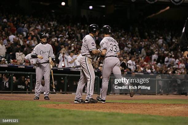 Scott Podsednik of the Chicago White Sox greets teammate Aaron Rowand during Game Three of the Major League Baseball World Series against the Houston...